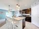 Modern kitchen with island, dark cabinetry and stainless steel appliances at 1526 White Hawk Way, Groveland, FL 34736