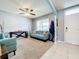 Living room with teal sofas, ceiling fan, and neutral walls at 1526 White Hawk Way, Groveland, FL 34736