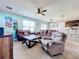 Spacious living room with brown leather sofas and a large TV at 1526 White Hawk Way, Groveland, FL 34736