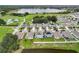 Aerial view of neighborhood with lake and houses with solar panels at 1526 White Hawk Way, Groveland, FL 34736