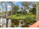 Expansive lakefront view with lush landscaping and a tranquil setting at 9164 Point Cypress Dr, Orlando, FL 32836