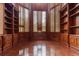 Spacious library with built-in bookshelves and hardwood floors at 9164 Point Cypress Dr, Orlando, FL 32836