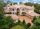 Grand two-story home with tile roof and manicured landscaping at 9164 Point Cypress Dr, Orlando, FL 32836