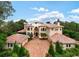 Grand estate home with tile roof and courtyard at 9164 Point Cypress Dr, Orlando, FL 32836