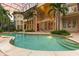 Inviting pool with a spacious patio and palm trees under a screened enclosure at 9164 Point Cypress Dr, Orlando, FL 32836