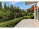 Private patio with lush landscaping and tile flooring at 9164 Point Cypress Dr, Orlando, FL 32836