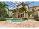 Inviting freeform pool with spa and screened enclosure at 9164 Point Cypress Dr, Orlando, FL 32836
