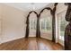 Bright bedroom with hardwood floors and arched windows at 9164 Point Cypress Dr, Orlando, FL 32836