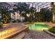 Relaxing pool and patio area with brick pavers and lush landscaping at 9164 Point Cypress Dr, Orlando, FL 32836