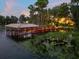 Private wooden dock extending over calm lake water at 9164 Point Cypress Dr, Orlando, FL 32836