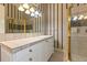 Bathroom with tiled shower and vanity with storage at 9164 Point Cypress Dr, Orlando, FL 32836