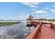 Private dock with covered seating area extends over calm lake water at 9164 Point Cypress Dr, Orlando, FL 32836
