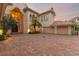 Mediterranean home features a three-car garage and beautiful landscaping at 9164 Point Cypress Dr, Orlando, FL 32836