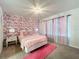 Bedroom with floral wallpaper and a queen bed at 3397 Lilac Way, Davenport, FL 33897