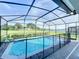 Screened-in rectangular pool with safety fence in backyard at 3397 Lilac Way, Davenport, FL 33897