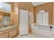 Bathroom with a bathtub, shower, and double vanity at 13728 Dornoch Dr, Orlando, FL 32828