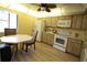 Kitchen with white appliances, wood cabinets and breakfast nook at 8 Escondido Cir # 79, Altamonte Springs, FL 32701