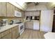 Kitchen with white appliances, wood cabinets and breakfast bar at 8 Escondido Cir # 79, Altamonte Springs, FL 32701