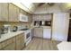 Kitchen with white appliances, wood cabinets and breakfast bar at 8 Escondido Cir # 79, Altamonte Springs, FL 32701
