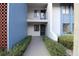 Condo building entry with walkway and landscaping at 8 Escondido Cir # 79, Altamonte Springs, FL 32701