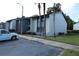 Two-story building exterior with landscaping and parking at 8 Escondido Cir # 79, Altamonte Springs, FL 32701