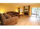 Bright living room with hardwood floors, fireplace and sliding glass doors at 8 Escondido Cir # 79, Altamonte Springs, FL 32701