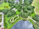 Community garden and walking paths alongside a serene lake at 217 Anastasia Dr, Kissimmee, FL 34759