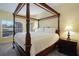 Main bedroom with a four-poster bed, nightstand, and soft carpeting at 217 Anastasia Dr, Kissimmee, FL 34759