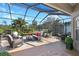 Spacious screened patio with hot tub, wicker furniture, and golf course views at 217 Anastasia Dr, Kissimmee, FL 34759