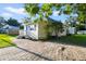 Yellow cottage with blue shutters and brick driveway at 1020 Wisconsin Ave, Saint Cloud, FL 34769