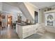 Kitchen features white cabinets, granite countertops, and island at 1020 Wisconsin Ave, St Cloud, FL 34769