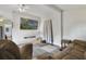 Living room with brown leather furniture, large TV, and wood floors at 1020 Wisconsin Ave, St Cloud, FL 34769