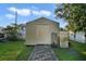 Outdoor storage shed with a paved pathway at 1020 Wisconsin Ave, St Cloud, FL 34769