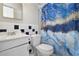 Bathroom with white vanity, toilet, and blue shower curtain at 1020 Wisconsin Ave, St Cloud, FL 34769