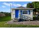 Cozy cottage with blue door and brick patio at 1020 Wisconsin Ave, St Cloud, FL 34769