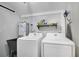 Bright laundry room with washer, dryer, and utility sink at 1020 Wisconsin Ave, St Cloud, FL 34769
