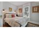 Cozy bedroom with a queen-size bed and large window at 1020 Wisconsin Ave, St Cloud, FL 34769