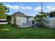 Charming cottage with a deck, fenced yard, and mature trees at 1020 Wisconsin Ave, St Cloud, FL 34769