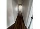 Long hallway with dark wood-look floors at 6648 Bouganvillea Crescent Dr, Orlando, FL 32809