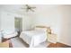 Bright bedroom with king-size bed, hardwood floors, and a sitting area at 9055 Treasure Trove Ln # 206, Kissimmee, FL 34747