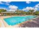 Resort-style pool with plenty of lounge chairs at 9055 Treasure Trove Ln # 206, Kissimmee, FL 34747