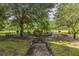 Peaceful lounge area with benches and grills near a pond at 9055 Treasure Trove Ln # 206, Kissimmee, FL 34747