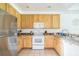 Kitchen with wood cabinets, stainless steel appliances at 9055 Treasure Trove Ln # 206, Kissimmee, FL 34747