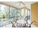 Relaxing screened porch with patio furniture and ceiling fan at 9055 Treasure Trove Ln # 206, Kissimmee, FL 34747