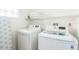 Convenient laundry room with washer, dryer, and storage shelves at 9055 Treasure Trove Ln # 206, Kissimmee, FL 34747