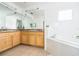 Bathroom with double vanity and large bathtub at 9055 Treasure Trove Ln # 206, Kissimmee, FL 34747