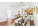 Open concept dining area with hardwood floors and kitchen access at 9055 Treasure Trove Ln # 206, Kissimmee, FL 34747