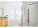 Spa-like bathroom with soaking tub, shower, and wood vanity at 9055 Treasure Trove Ln # 206, Kissimmee, FL 34747