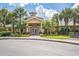 Community clubhouse with welcoming entrance and landscaping at 9055 Treasure Trove Ln # 206, Kissimmee, FL 34747