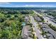 An aerial view of a residential neighborhood with houses, roads, and lush green surroundings at 452 Harbor Winds Ct, Winter Springs, FL 32708